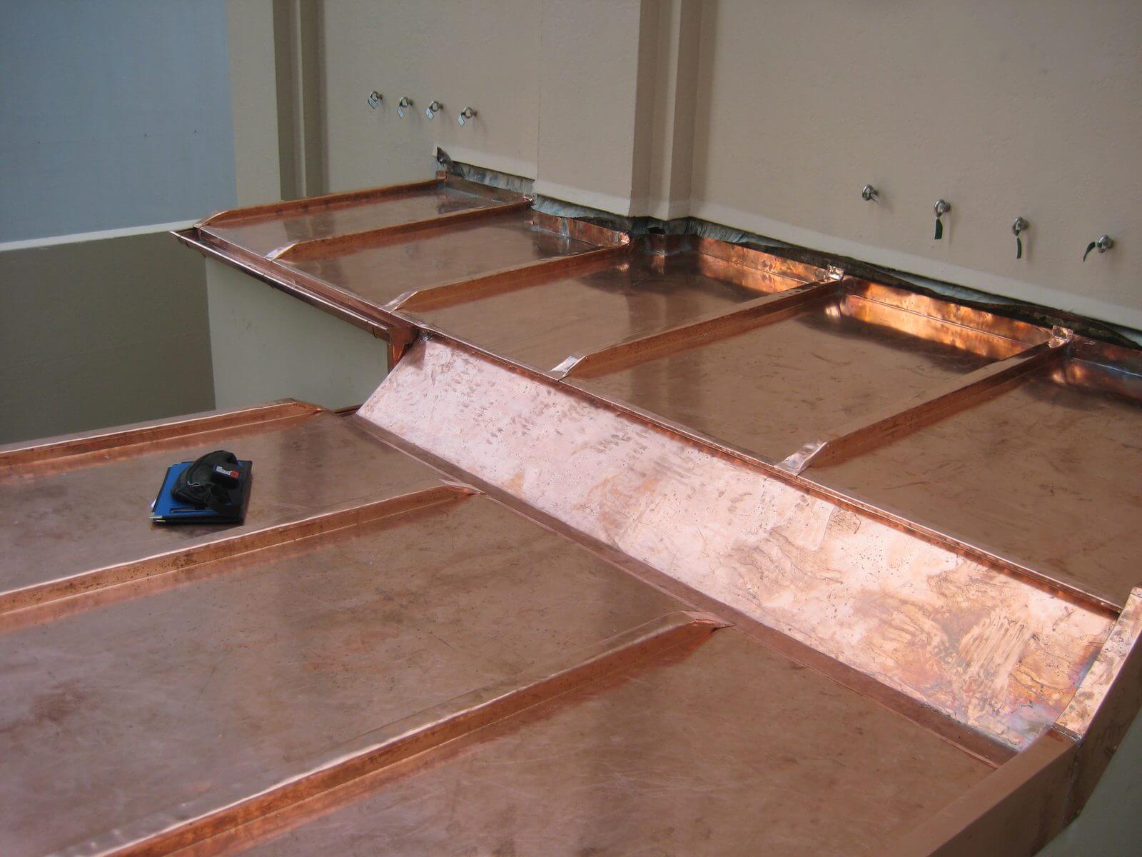 Close-up of a custom copper roof with stepped pans and welts