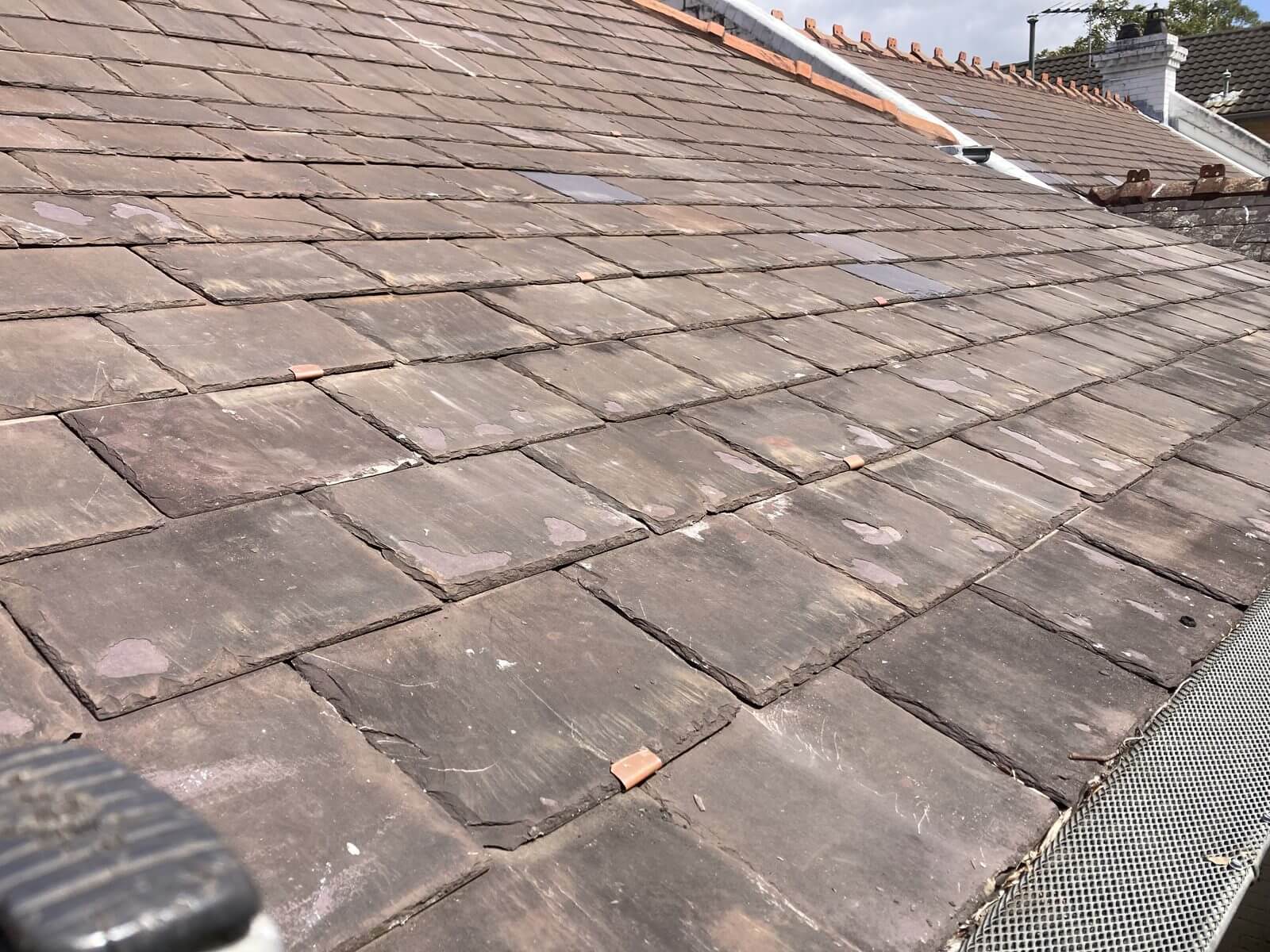 Repaired heritage slate roof with mixed weathered slates